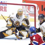 
              Shawinigan Cataractes goaltender Charles-Antoine Lavallee makes a save during the first period of the Memorial Cup hockey game against the Edmonton Oil Kings in Saint John, New Brunswick,  Tuesday, June 21, 2022. (Darren Calabrese/The Canadian Press via AP)
            