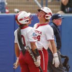 
              Oklahoma's Rylie Boone (0) and Jayda Coleman (24) celebrate at home plate after scoring in the third inning of an NCAA softball Women's College World Series game against Northwestern on Thursday, June 2, 2022, in Oklahoma City. (AP Photo/Alonzo Adams)
            
