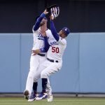 
              Los Angeles Dodgers right fielder Mookie Betts, right, collides with center fielder Cody Bellinger after making a catch on a ball hit by Los Angeles Angels' Taylor Ward during the first inning of a baseball game Wednesday, June 15, 2022, in Los Angeles. Betts lost control of the ball after the collision but Ward was thrown out at second by Bellinger. (AP Photo/Mark J. Terrill)
            