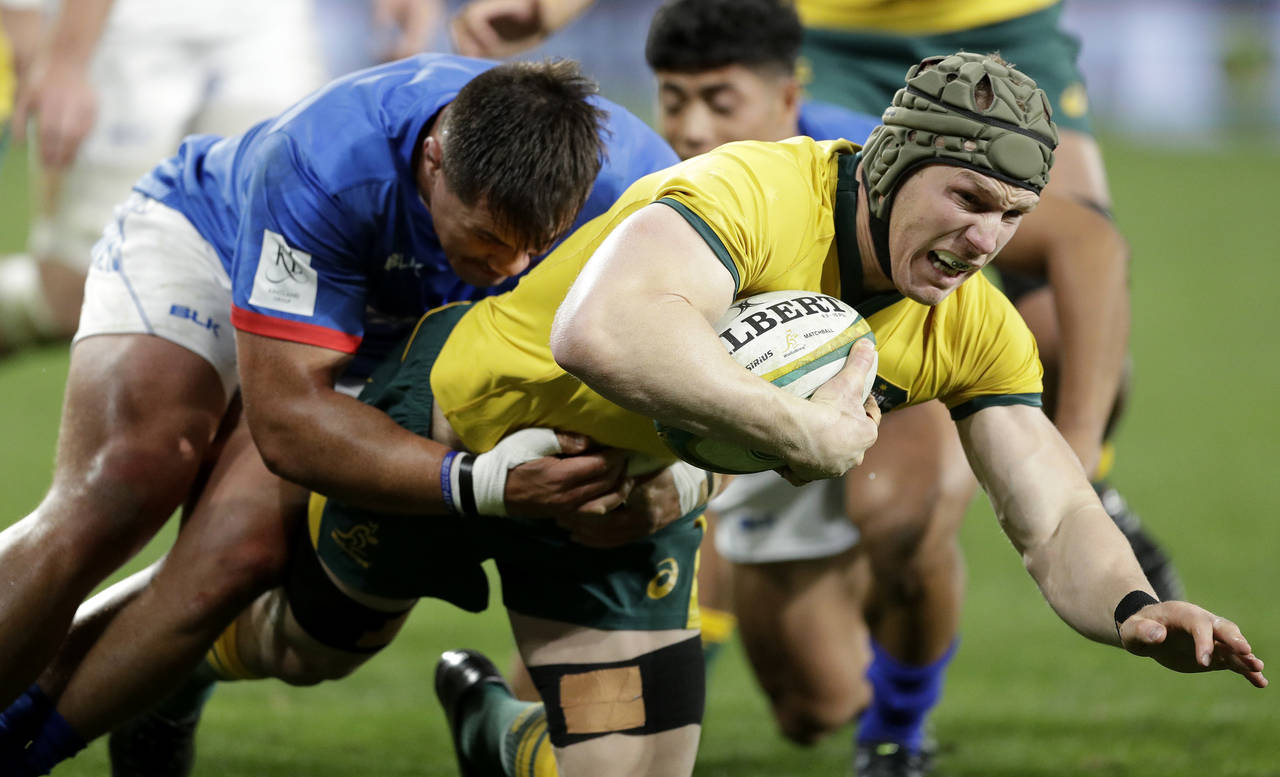 FILE - Australia's David Pocock, right, is tackled by Samoa's Jordan Lay during their rugby union t...