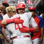
              Philadelphia Phillies' Kyle Schwarber, back, hugs Yairo Munoz in the dugout after Schwarber's two-run home run against the Washington Nationals during the third inning of a baseball game Thursday, June 16, 2022, in Washington. (AP Photo/Nick Wass)
            