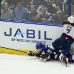 
              Colorado Avalanche defenseman Devon Toews (7) takes down Tampa Bay Lightning right wing Nikita Kucherov (86) during the third period of Game 3 of the NHL hockey Stanley Cup Final on Monday, June 20, 2022, in Tampa, Fla. (AP Photo/Chris O'Meara)
            