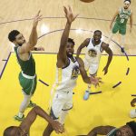 
              Golden State Warriors forward Andrew Wiggins, middle, shoots against the Boston Celtics during the first half of Game 2 of basketball's NBA Finals in San Francisco, Sunday, June 5, 2022. (AP Photo/Jed Jacobsohn, Pool)
            