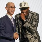 
              Malaki Branham reacts as he shakes hands with NBA Commissioner Adam Silver after being selected 20th overall in the NBA basketball draft, Thursday, June 23, 2022, in New York. (AP Photo/John Minchillo)
            
