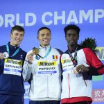 
              Silver medalist Maxime Grousset of France, left, gold medalist David Popovici of Romania, centre, bronze medalist Joshua Liendo Edwards of Canada, right, pose with their medals after the Men 100m Freestyle final at the 19th FINA World Championships in Budapest, Hungary, Wednesday, June 22, 2022. (AP Photo/Petr David Josek)
            