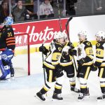 
              Members of the Hamilton Bulldogs celebrate a first period goal in front of Saint John Sea Dogs goaltender Nikolas Hurtubise (31) during a Memorial Cup hockey game in Saint John, Canada, on Monday, June 20, 2022. (Darren Calabrese/The Canadian Press via AP)
            