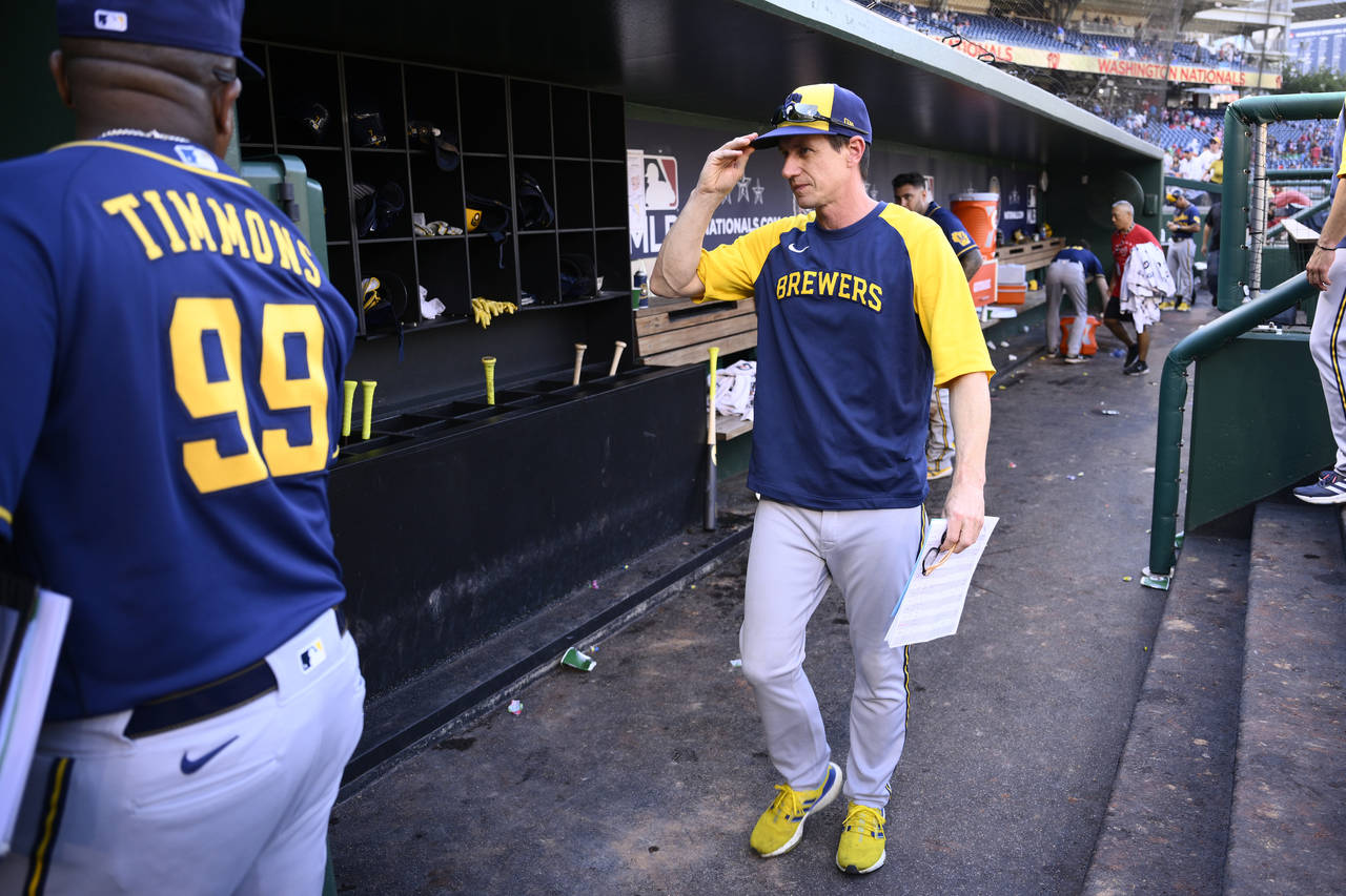 Milwaukee Brewers manager Craig Counsell walks in the dugout after a baseball game against the Wash...