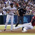 
              Detroit Tigers third baseman Harold Castro (30) forces out Arizona Diamondbacks' Pavin Smith (26) at third base as umpire Roberto Ortiz looks on during the sixth inning of a baseball game Sunday, June 26, 2022, in Phoenix. (AP Photo/Ross D. Franklin)
            