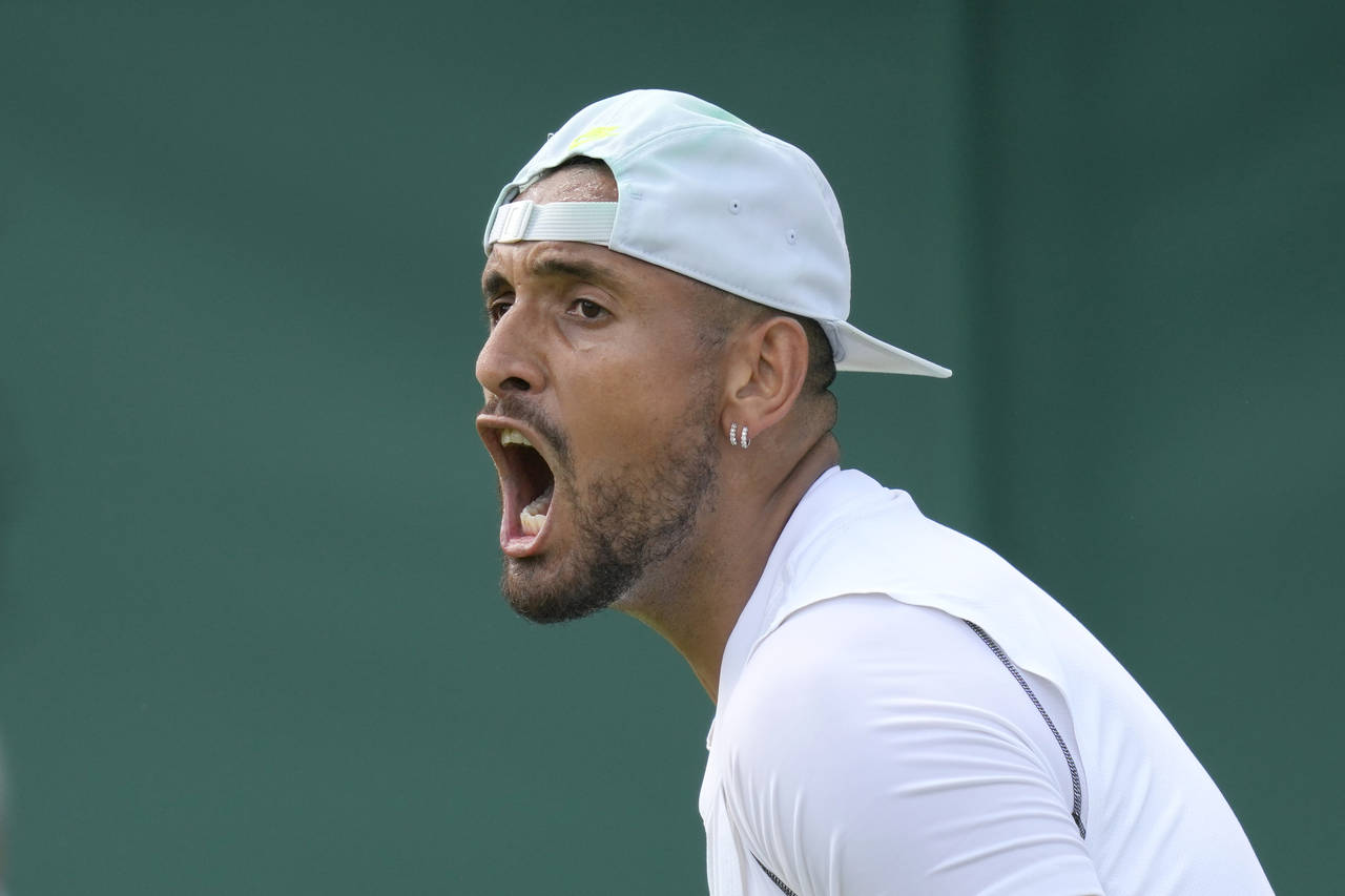Australia's Nick Kyrgios celebrates retaining a service game during the singles tennis match agains...