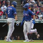
              Texas Rangers' Corey Seager, left, greets Marcus Semien after his solo home run off Cleveland Guardians starting pitcher Kirk McCarty during the third inning of the second game of a baseball doubleheader in Cleveland, Tuesday, June 7, 2022. (AP Photo/Phil Long)
            