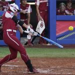 
              Oklahoma's Taylon Snow hits a home run against Texas during the first inning of the first game of the NCAA Women's College World Series softball championship series Wednesday, June 8, 2022, in Oklahoma City. (AP Photo/Sue Ogrocki)
            