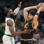
              Golden State Warriors guard Klay Thompson (11) looks to pass against Boston Celtics guard Jaylen Brown (7) during the first quarter of Game 3 of basketball's NBA Finals, Wednesday, June 8, 2022, in Boston. (AP Photo/Steven Senne)
            