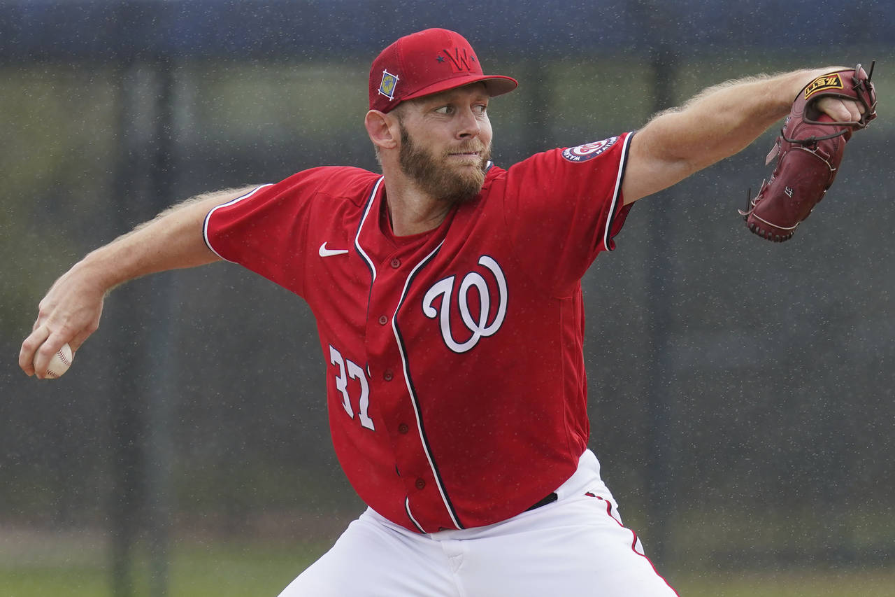 FILE - Washington Nationals pitcher Stephen Strasburg throws live batting practice in a drizzle dur...