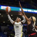 
              Dallas Wings guard Arike Ogunbowale (24) shoots as Indiana Fever center Queen Egbo (4) defends during the first half of a WNBA basketball game Thursday, June 23, 2022, in Arlington, Texas. (AP Photo/Tony Gutierrez)
            