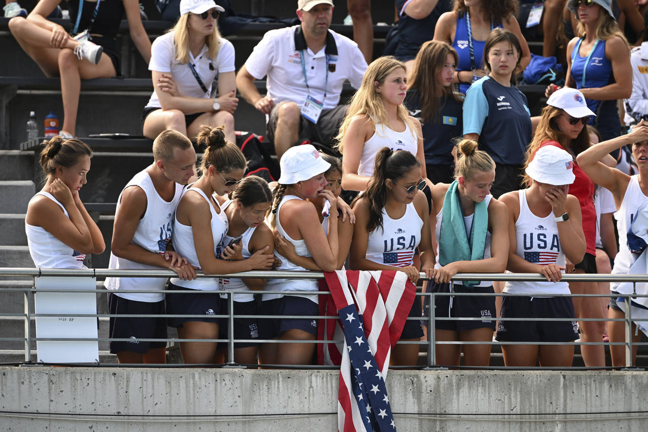 Fans and teammates react after Anita Alvarez of United States collapsed during the solo free final ...