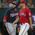 
              Washington Nationals' Nelson Cruz, left, walks past Texas Rangers starting pitcher Dane Dunning, right, on his way to the dugout after being thrown out at home while trying to score on a Keibert Ruiz single in the fourth inning of a baseball game, Friday, June 24, 2022, in Arlington, Texas. (AP Photo/Tony Gutierrez)
            