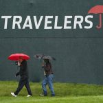 
              Fans walk in the rain during the Travelers Celebrity Pro-Am golf tournament at TPC River Highlands, Wednesday, June 22, 2022, in Cromwell, Conn. This week's Travelers Championship will feature six of the world's top 15 ranked players, including No. 1 Scottie Scheffler and No. 2 Rory McIlroy. McIlroy, who won the Canadian Open earlier this month and then finished tied for fifth at last week's U.S. Open, is playing in his fourth straight event. (AP Photo/Seth Wenig)
            