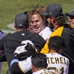 
              Pittsburgh Pirates' Jack Suwinski, center, is swarmed by teammates after hitting a walkoff solo home run off San Francisco Giants relief pitcher Tyler Rogers during the ninth inning of a baseball game in Pittsburgh, Sunday, June 19, 2022. It was Suwinski's third solo home run of the game. (AP Photo/Gene J. Puskar)
            