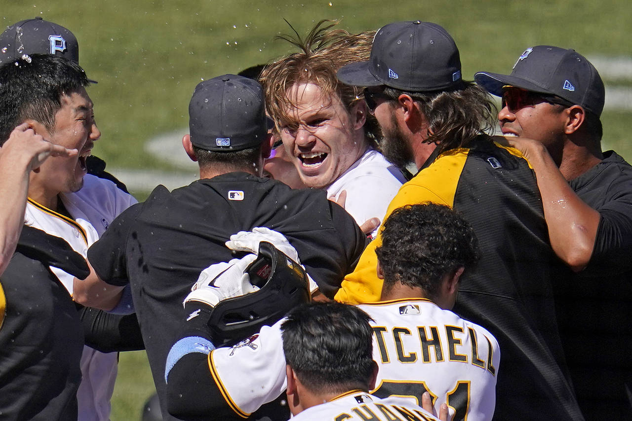 Pittsburgh Pirates' Jack Suwinski, center, is swarmed by teammates after hitting a walkoff solo hom...