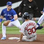
              Boston Red Sox's Rob Refsnyder (30) is out at second base on an attempted steal with a tag from Toronto Blue Jays' Matt Chapman (26) during the first inning of a baseball game Tuesday, June 28, 2022, in Toronto. (Jon Blacker/The Canadian Press via AP)
            