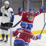 
              Edmonton Oil Kings' Jaxsen Wiebe, right, celebrates his overtime goal with Kaiden Guhle, next to Saint John Sea Dogs' Vincent Sevigny in a Memorial Cup hockey game Wednesday, June 22, 2022, in Saint John, New Brunswick. (Darren Calabrese/The Canadian Press via AP)
            