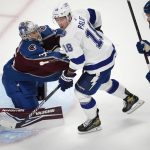 
              Tampa Bay Lightning left wing Ondrej Palat, center, drives past Colorado Avalanche defenseman Cale Makar, right, as goaltender Darcy Kuemper protects the net during the first period of Game 5 of the NHL hockey Stanley Cup Final on Friday, June 24, 2022, in Denver. (AP Photo/David Zalubowski)
            