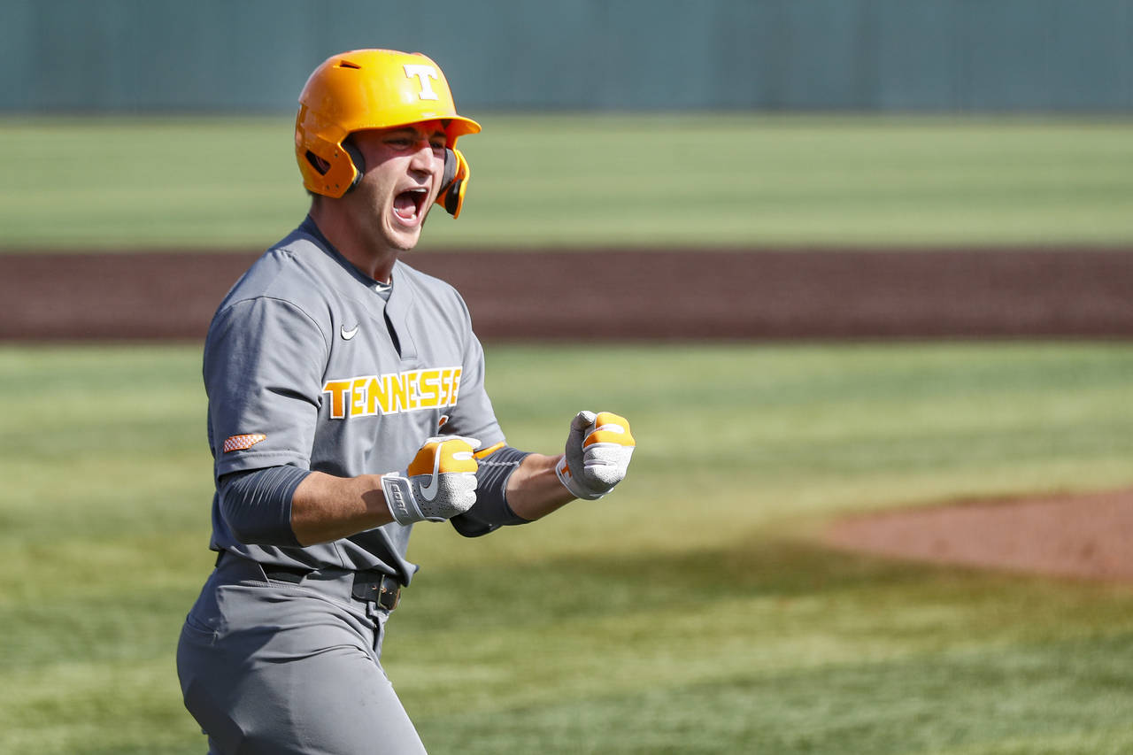FILE -Tennessee outfielder Evan Russell (6) reacts to hitting a home run during an NCAA college bas...