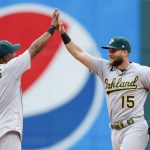 
              Oakland Athletics' Seth Brown (15) and Elvis Andrus (17) celebrate a win over the Cleveland Guardians in a baseball game, Saturday, June 11, 2022, in Cleveland. (AP Photo/Ron Schwane)
            