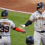 
              San Francisco Giants' Joc Pederson, right, is greeted by Thairo Estrada (39) as he returns to the dugout after hitting a solo home run off Pittsburgh Pirates starting pitcher Zach Thompson during the fourth inning of a baseball game in Pittsburgh, Friday, June 17, 2022. (AP Photo/Gene J. Puskar)
            