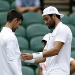 
              Italy's Matteo Berrettini checks out the clothing worn by Serbia's Novak Djokovic on centre court ahead of the 2022 Wimbledon Championship at the All England Lawn Tennis and Croquet Club, Wimbledon, Thursday June 23, 2022. (Steven Paston/PA via AP)
            