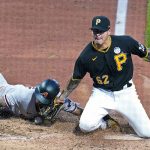 
              Arizona Diamondbacks' David Peralta, left, scores on a wild pitch by Pittsburgh Pirates reliever Anthony Banda (52) during the fifth inning of a baseball game in Pittsburgh, Friday, June 3, 2022. (AP Photo/Gene J. Puskar)
            