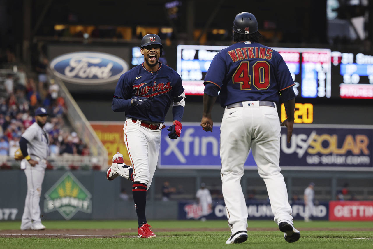 Minnesota Twins' Byron Buxton smiles on his way to home plate after hitting his second home run of ...
