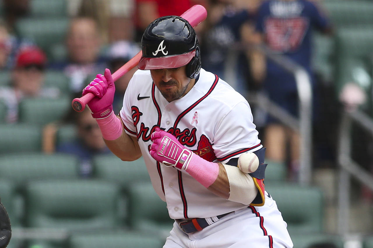 Atlanta Braves center fielder Adam Duvall (14) is hit by a pitch in the fifth inning of a baseball ...