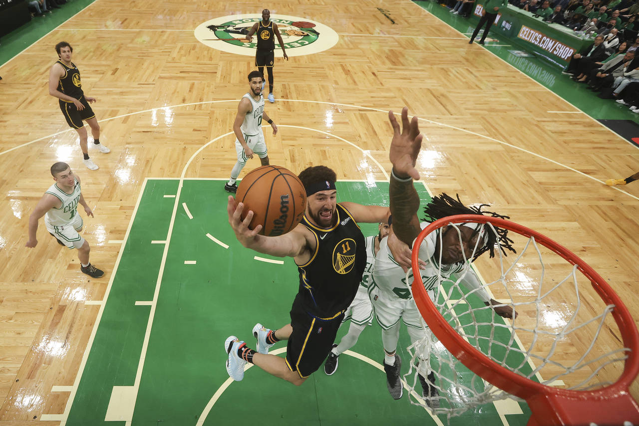 Golden State Warriors guard Klay Thompson (11) puts up a shot against Boston Celtics center Robert ...