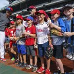 
              Philadelphia Phillies' Bryson Stott, left, poses with West Chester'sCaden Marge, sixth from right, and a bunch of fans during warmups prior to a baseball game against the Arizona Diamondbacks, Friday, June 10, 2022, in Philadelphia. (AP Photo/Chris Szagola)
            