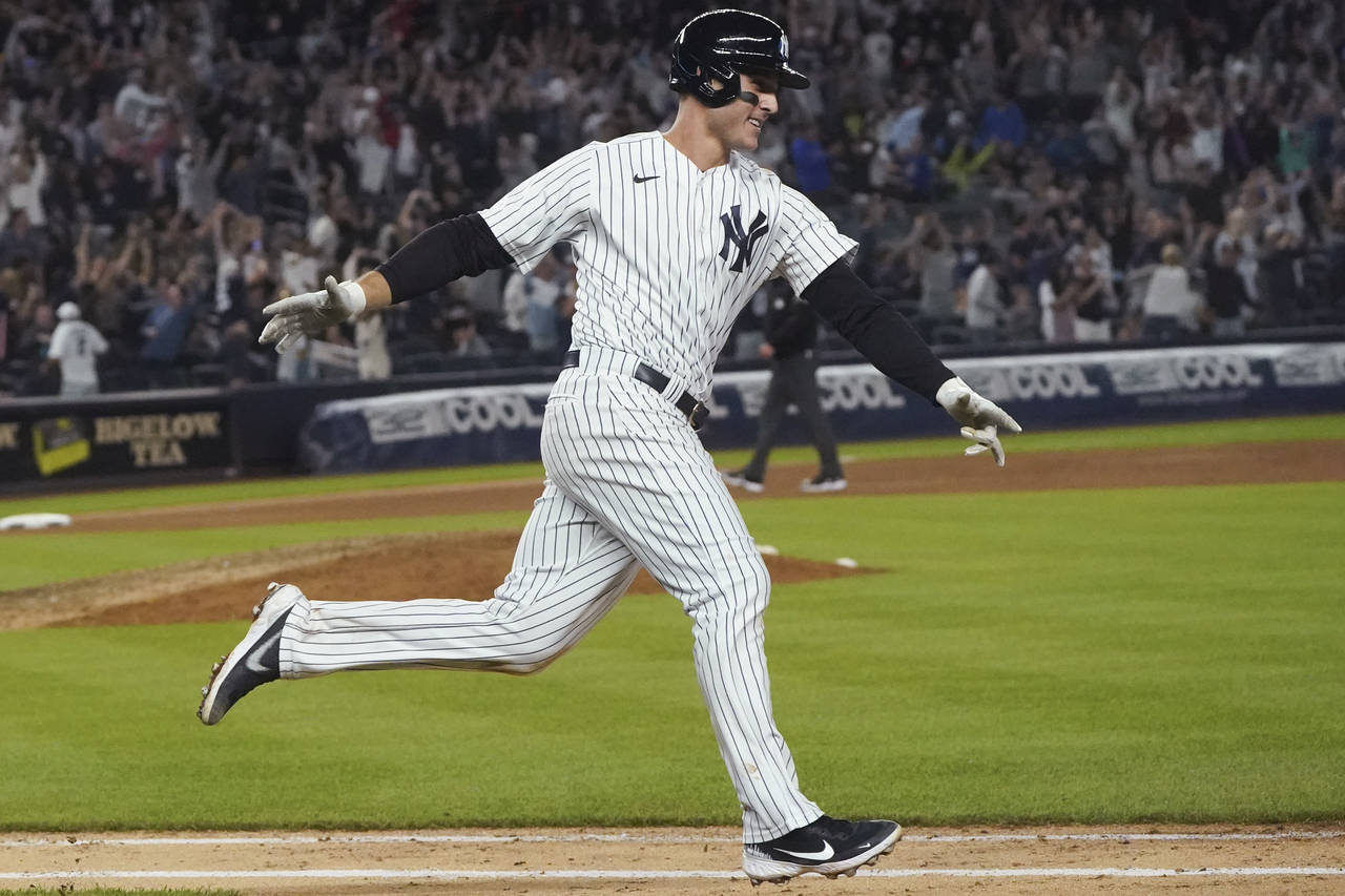 New York Yankees' Anthony Rizzo runs the bases on his game-ending home run in the ninth inning of t...