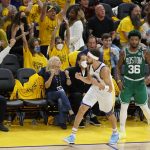 
              CORRECTS TO GAME 2 INSTEAD OF GAME 1- Golden State Warriors guard Klay Thompson, bottom, celebrates after scoring in front of Boston Celtics guard Marcus Smart (36) during the second half of Game 2 of basketball's NBA Finals in San Francisco, Sunday, June 5, 2022. (AP Photo/John Hefti)
            