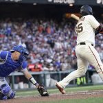 
              Los Angeles Dodgers catcher Will Smith, left, reaches for a wild pitch from Craig Kimbrel next to San Francisco Giants' Brandon Crawford, right, that allowed Joc Pederson to score during the eighth inning of a baseball game in San Francisco, Saturday, June 11, 2022. (AP Photo/Jeff Chiu)
            