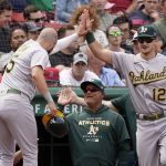 
              Oakland Athletics' Seth Brown (15) is congratulated at the dugout by teammate Sean Murphy (12) after scoring on an error by Boston Red Sox third baseman Rafael Devers during the sixth inning of a baseball game at Fenway Park, Thursday, June 16, 2022, in Boston. (AP Photo/Mary Schwalm)
            