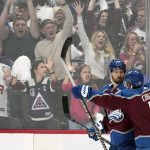 
              Colorado Avalanche center Darren Helm, left, celebrates his goal against the Tampa Bay Lightning with center Andrew Cogliano (11) during the second period in Game 2 of the NHL hockey Stanley Cup Final, Saturday, June 18, 2022, in Denver. (AP Photo/John Locher)
            