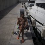 
              A man sunbathes during a heat wave in Marseille, southern France, Wednesday, June 15, 2022. (AP Photo/Daniel Cole)
            