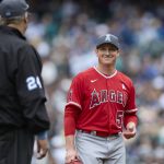 
              Los Angeles Angels starting pitcher Kenny Rosenberg, right, smiles at the umpire as he leaves during the sixth inning of a win over the Seattle Mariners, Sunday, June 19, 2022, in Seattle. (AP Photo/John Froschauer)
            