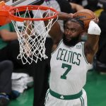
              Boston Celtics guard Jaylen Brown (7) dunks the ball against the Golden State Warriors during the second quarter of Game 3 of basketball's NBA Finals, Wednesday, June 8, 2022, in Boston. (AP Photo/Michael Dwyer)
            