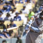 
              Cleveland Guardians' Josh Naylor hits a double during the ninth inning of a baseball game against the Los Angeles Dodgers in Los Angeles, Sunday, June 19, 2022. (AP Photo/Kyusung Gong)
            