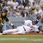 
              Los Angeles Dodgers' Gavin Lux, right, is tagged out by Pittsburgh Pirates catcher Tyler Heineman while trying to score after Justin Turner flied out during the seventh inning of a baseball game Wednesday, June 1, 2022, in Los Angeles. (AP Photo/Mark J. Terrill)
            