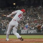 
              Los Angeles Angels' Mike Trout hits a solo home run against the Seattle Mariners during the third inning of the second baseball game of a doubleheader Saturday, June 18, 2022, in Seattle. (AP Photo/Ted S. Warren)
            