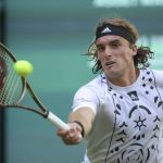 
              Stefanos Tsitsipas of Greece returns to France's Benjamin Bonzi during their match at the ATP tennis tournament in Halle, Germany, Tuesday, June 14, 2022. (Friso Gentsch/dpa via AP)
            
