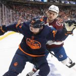 
              Colorado Avalanche's Bowen Byram (4) and Edmonton Oilers' Warren Foegele (37) battle for the puck during second period NHL hockey conference finals action in Edmonton, Alberta, on Monday, June 6, 2022. (Jason Franson/The Canadian Press via AP)
            