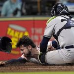 
              Houston Astros' Kyle Tucker, left, is tagged out by New York Yankees catcher Jose Trevino (39) while trying to steal home plate during the third inning of a baseball game Thursday, June 30, 2022, in Houston. (AP Photo/David J. Phillip)
            