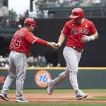 
              Los Angeles Angels' Mike Trout, right, is greeted by third base coach Mike Gallego after hitting a two-run home run off a pitch from Seattle Mariners starting pitcher Logan Gilbert during the fourth inning of a baseball game Sunday, June 19, 2022, in Seattle. (AP Photo/John Froschauer)
            
